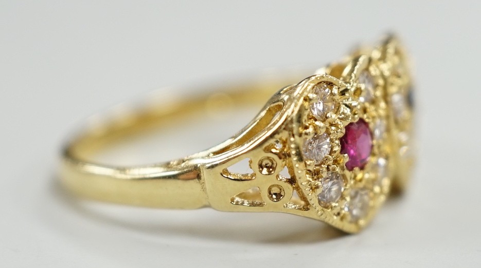 A modern 18ct gold, ruby, sapphire and diamond set twin heart cluster ring, size M, gross weight 4 grams.